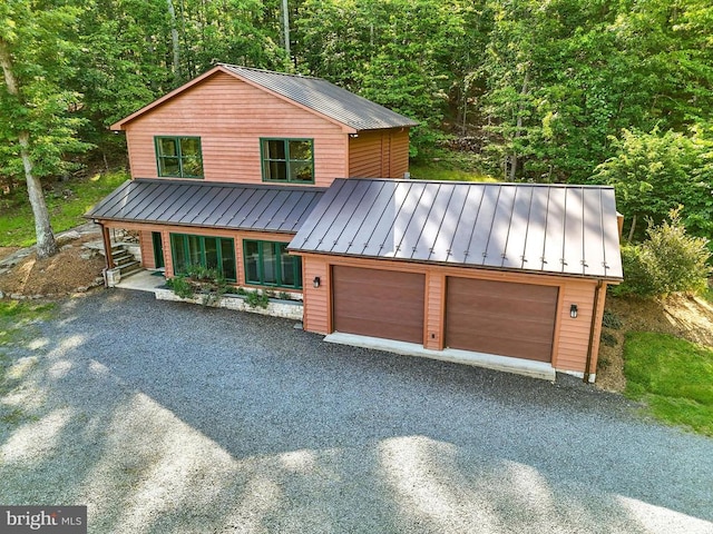 103 Castleton Ford Rd, Castleton, VA 22716 - chalet / cabin with a standing seam roof, metal roof, a forest view, a garage, and driveway