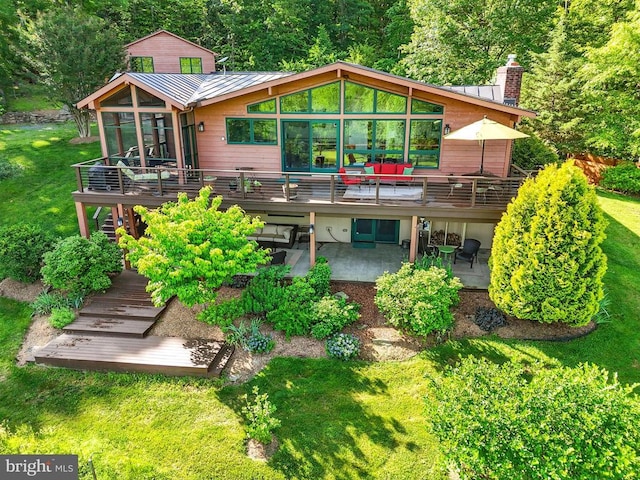 103 Castleton Ford Rd, Castleton, VA 22716 - back of house with a wooden deck, a sunroom, a patio area, a standing seam roof, and metal roof