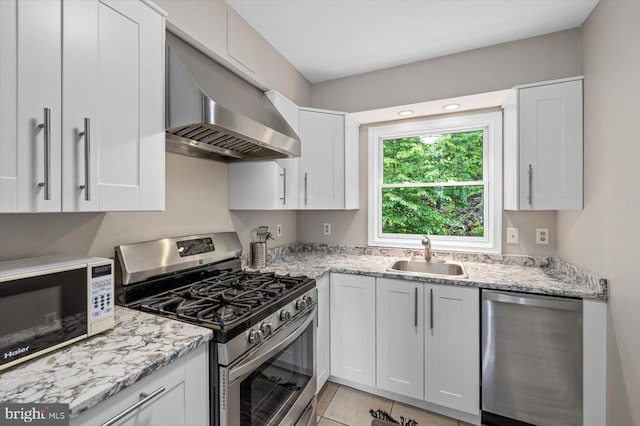 103 Castleton Ford Rd, Castleton, VA 22716 - kitchen featuring appliances with stainless steel finishes, a sink, wall chimney range hood, white cabinetry, and light stone countertops
