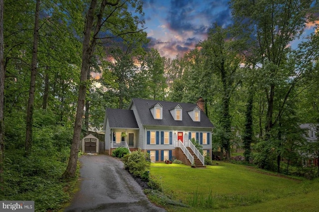 1218 Heatherbrook Ct, Fredericksburg, VA 22407 - cape cod-style house featuring a porch, a chimney, a lawn, asphalt driveway, and stairway