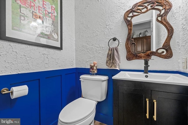 1218 Heatherbrook Ct, Fredericksburg, VA 22407 - half bath with a textured wall, vanity, toilet, a decorative wall, and a wainscoted wall