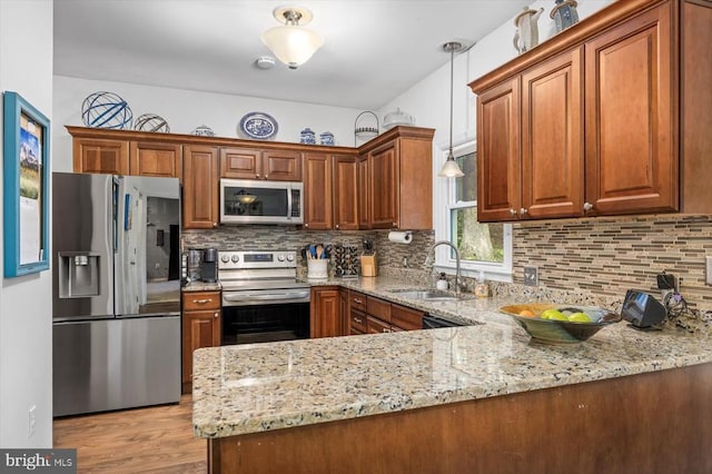 1218 Heatherbrook Ct, Fredericksburg, VA 22407 - kitchen with stainless steel appliances, a sink, light stone countertops, decorative backsplash, and brown cabinetry