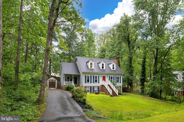 1218 Heatherbrook Ct, Fredericksburg, VA 22407 - cape cod home with a chimney, stairway, asphalt driveway, a front lawn, and covered porch