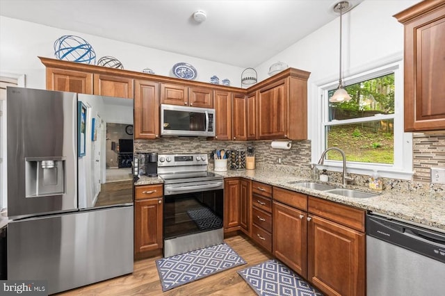 1218 Heatherbrook Ct, Fredericksburg, VA 22407 - kitchen featuring stainless steel appliances, a sink, light wood-style flooring, light stone counters, and tasteful backsplash