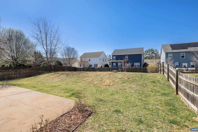 view of yard with a fenced backyard and a residential view