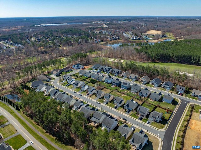 drone / aerial view featuring a water view and a residential view