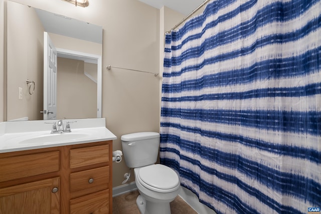 bathroom with toilet, a shower with curtain, vanity, tile patterned flooring, and baseboards