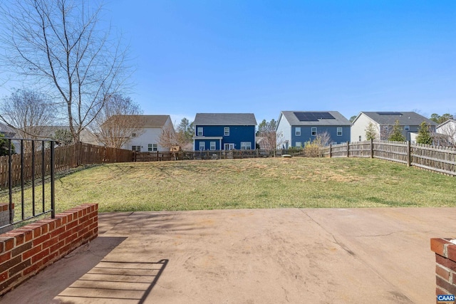 view of patio with a residential view and a fenced backyard