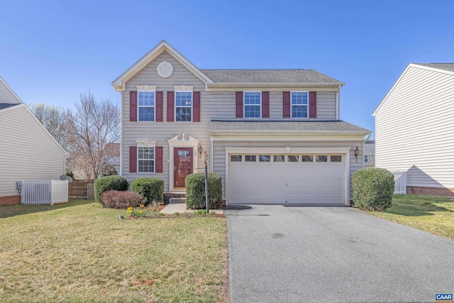 traditional home with a garage, fence, a shingled roof, a front yard, and driveway
