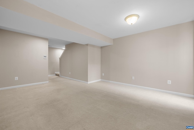 interior space featuring light carpet and baseboards