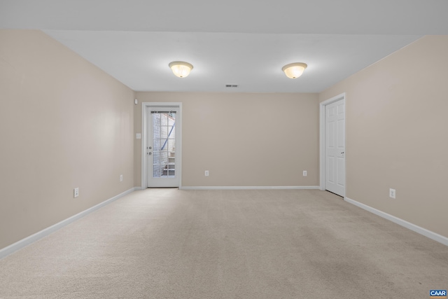 spare room with light carpet, baseboards, and visible vents