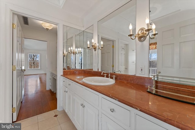  - full bath with a chandelier, vanity, tile patterned floors, and an enclosed shower