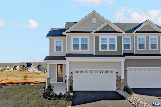 403 Bayberry Ln, Zion Crossroads, VA 22942 - view of front of property with asphalt driveway, an attached garage, stone siding, and board and batten siding