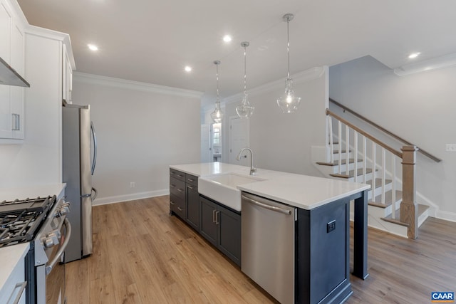 403 Bayberry Ln, Zion Crossroads, VA 22942 - kitchen featuring stainless steel appliances, white cabinets, an island with sink, light wood-style flooring, and light countertops