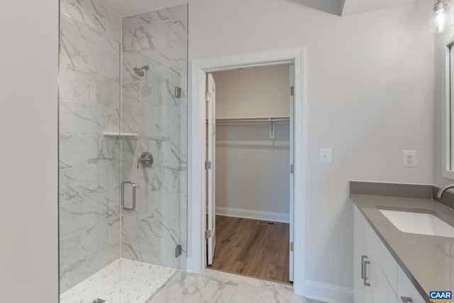 403 Bayberry Ln, Zion Crossroads, VA 22942 - bathroom with a marble finish shower, vanity, a spacious closet, and marble look tiles