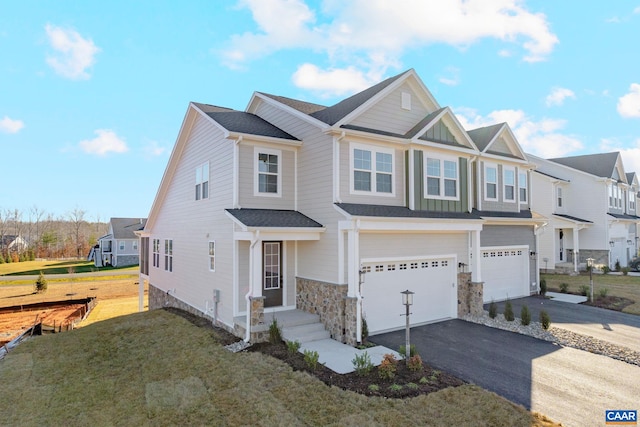 403 Bayberry Ln, Zion Crossroads, VA 22942 - view of front of house with an attached garage, asphalt driveway, stone siding, a front lawn, and a residential view