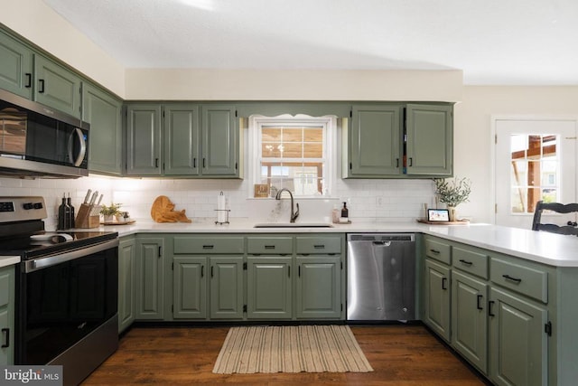 114 Wanda St W, Stanley, VA 22851 - kitchen featuring appliances with stainless steel finishes, green cabinets, a peninsula, and light countertops