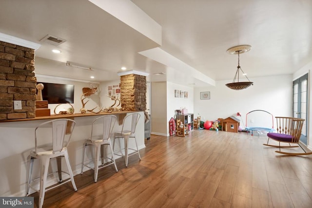114 Wanda St W, Stanley, VA 22851 - kitchen with wood finished floors, a breakfast bar area, hanging light fixtures, and recessed lighting