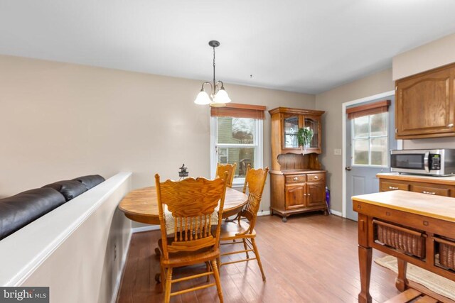 11404 Warner Dr, Fredericksburg, VA 22407 - dining room featuring light wood-style floors, healthy amount of natural light, and a chandelier