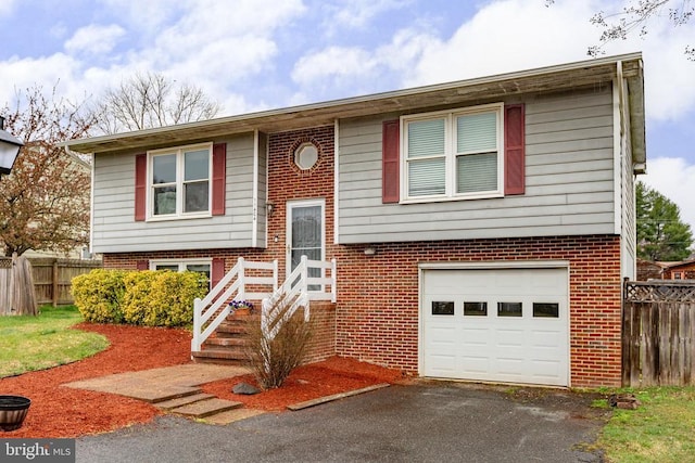 11404 Warner Dr, Fredericksburg, VA 22407 - split foyer home with an attached garage, fence, and brick siding