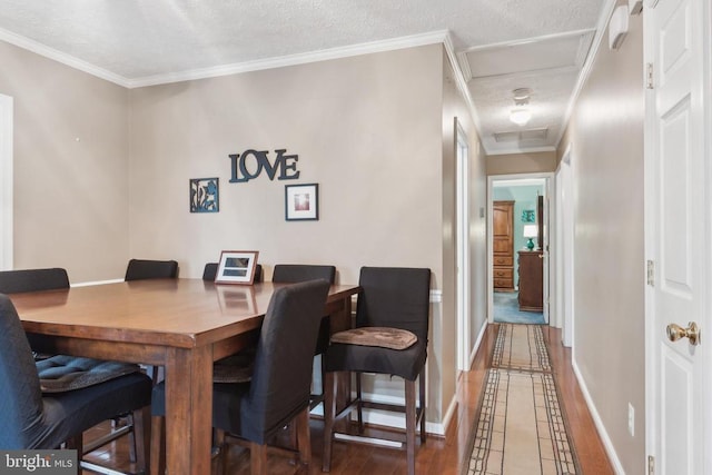 7408 Ryan Ct, Reva, VA 22735 - dining area with attic access, baseboards, a textured ceiling, crown molding, and inlaid floor details