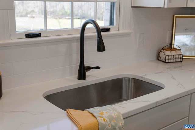 912 Shores Rd, Palmyra, VA 22963 - room details with backsplash, white cabinetry, and a sink
