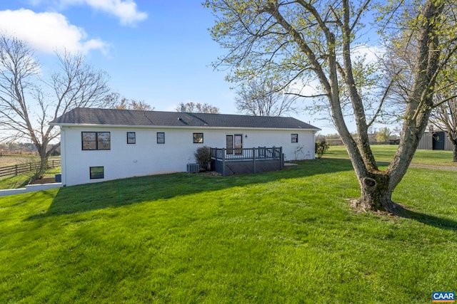 912 Shores Rd, Palmyra, VA 22963 - back of house featuring a lawn, brick siding, fence, central air condition unit, and a wooden deck