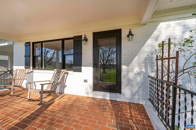 912 Shores Rd, Palmyra, VA 22963 - doorway to property with covered porch and brick siding