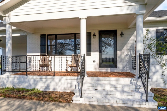 912 Shores Rd, Palmyra, VA 22963 - doorway to property featuring covered porch and brick siding