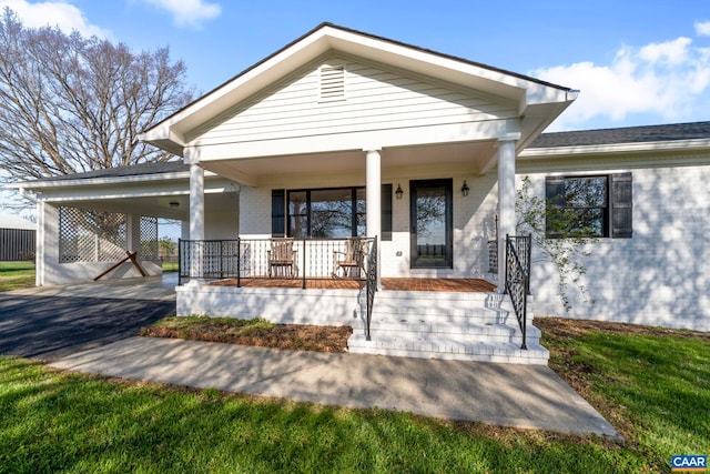 912 Shores Rd, Palmyra, VA 22963 - bungalow-style home with covered porch, brick siding, driveway, and an attached carport