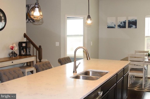 2437 Drake Ln, Fredericksburg, VA 22408 - kitchen featuring a sink, light stone countertops, hanging light fixtures, and dark wood-type flooring