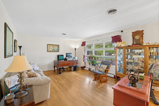708 Woodside Ln, Waynesboro, VA 22980 - living room with light wood finished floors, a desk, and a baseboard radiator