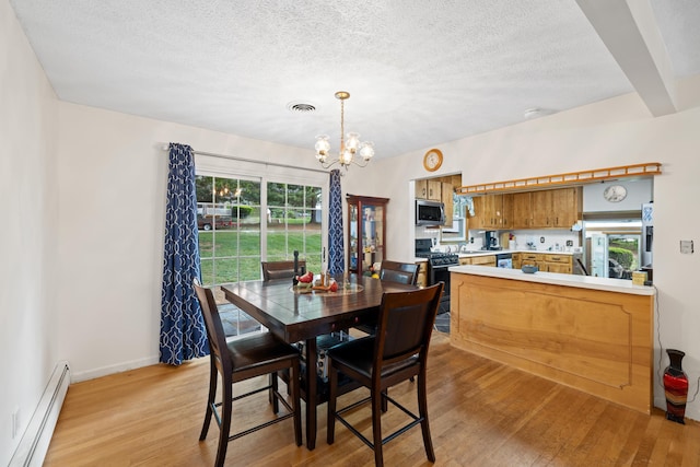 708 Woodside Ln, Waynesboro, VA 22980 - dining space featuring a baseboard radiator, light wood finished floors, a chandelier, and a textured ceiling