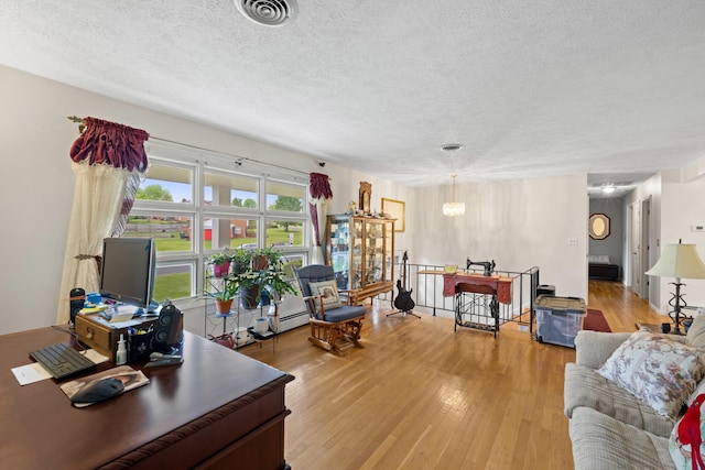 708 Woodside Ln, Waynesboro, VA 22980 - living room featuring a textured ceiling, light wood finished floors, and a chandelier