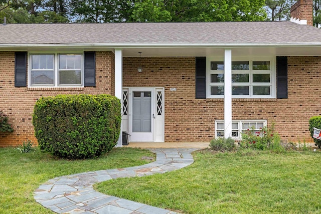 708 Woodside Ln, Waynesboro, VA 22980 - property entrance with a lawn, a chimney, brick siding, and a shingled roof