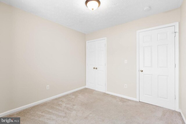 2912 Broyhill Ct, Fredericksburg, VA 22408 - unfurnished bedroom with carpet flooring, baseboards, a closet, and a textured ceiling