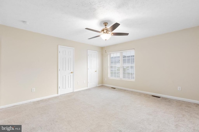 2912 Broyhill Ct, Fredericksburg, VA 22408 - unfurnished bedroom with carpet, baseboards, two closets, and a ceiling fan