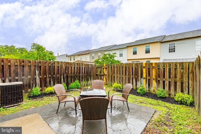 2912 Broyhill Ct, Fredericksburg, VA 22408 - fenced backyard with central AC unit, a patio area, outdoor dining area, and a residential view
