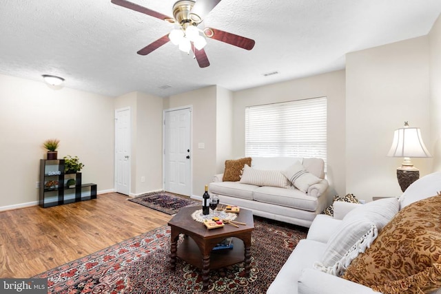 2912 Broyhill Ct, Fredericksburg, VA 22408 - living room with wood finished floors, a ceiling fan, baseboards, and a textured ceiling
