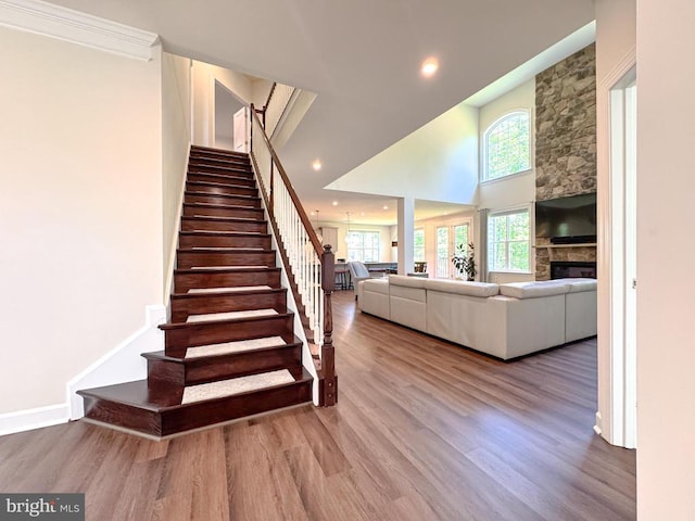 8525 Laroque Run Dr, Fredericksburg, VA 22407 - stairs with wood finished floors, a stone fireplace, recessed lighting, and a high ceiling