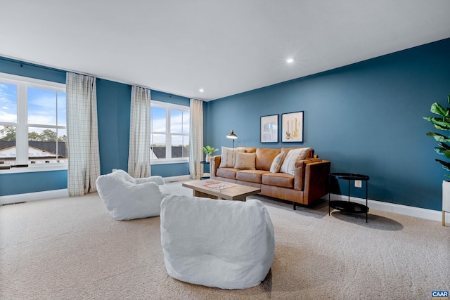 carpeted living room featuring baseboards, recessed lighting, and visible vents