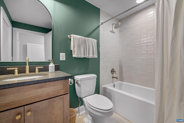 full bathroom featuring toilet, shower / tub combo, baseboards, and vanity