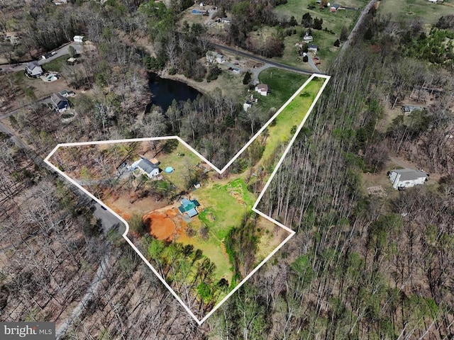 aerial view of property and surrounding area featuring property boundaries highlighted and a nearby body of water