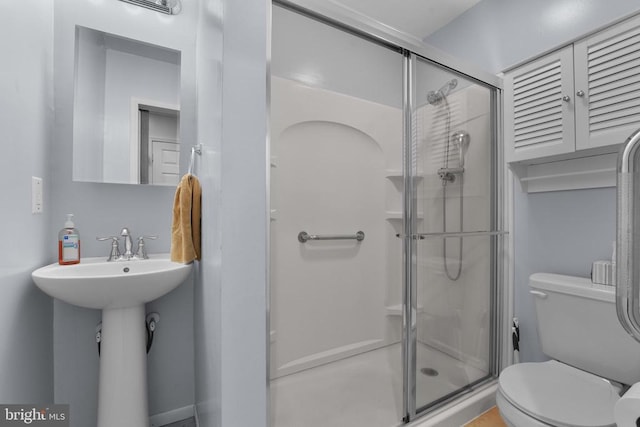 full bathroom with a stall shower and toilet