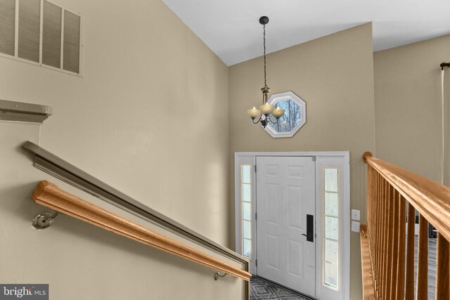 foyer entrance with a chandelier