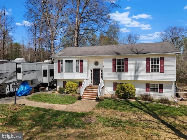 raised ranch with a front yard