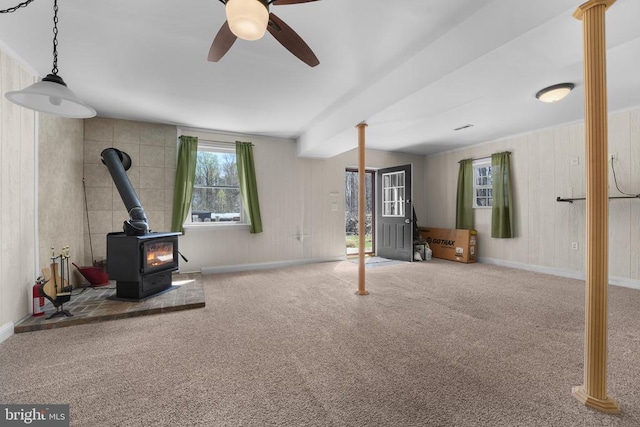 19303 Frazier Rd, Culpeper, VA 22701 - unfurnished living room featuring a wood stove, carpet floors, and a ceiling fan