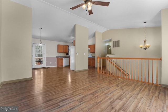 unfurnished living room featuring vaulted ceiling, wood finished floors, ceiling fan, a chandelier, and baseboards
