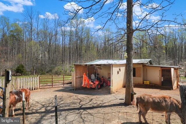 19303 Frazier Rd, Culpeper, VA 22701 - view of outdoor structure with fence, a wooded view, and a carport