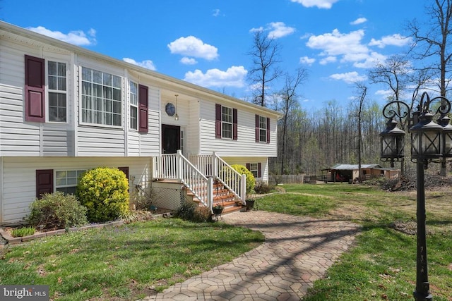 bi-level home with a front lawn
